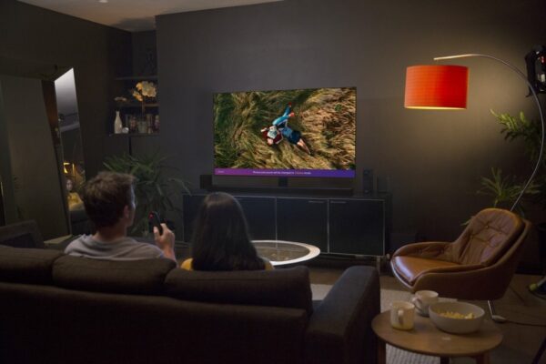 A couple watching a movie together on an LG TV.